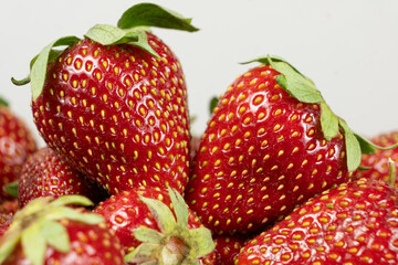 Ripe strawberries background. Sweet seasonal fruit concept.