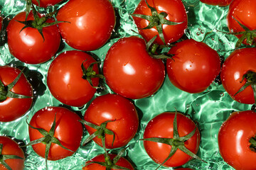 Clean Ripe Tomatoes Dropped into Water Top View