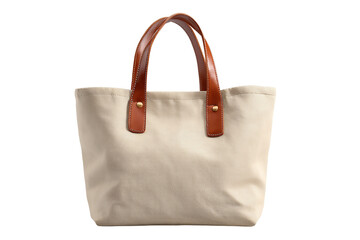 A simple beige canvas tote bag with brown leather handles is isolated on transparent background, perfect for casual outings
