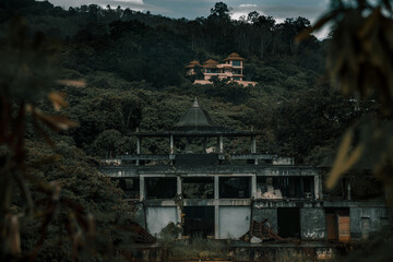 Old abandoned hotel in the jungle. Shabby walls. Beautiful abandoned hotel.