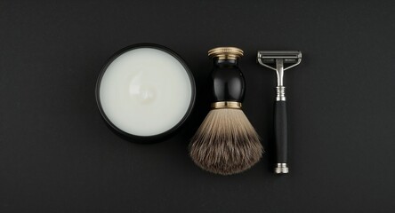 Fototapeta premium Luxury shaving kit with brush cream and razor set on plain black background