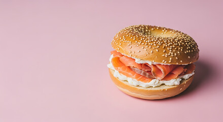Sesame Bagel with Smoked Salmon and Cream Cheese on Pink Background