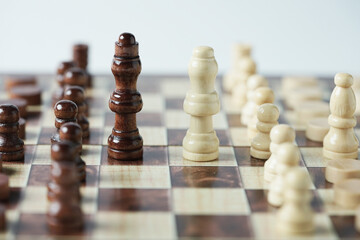 The confrontation between chess brown king and white queen. Chess pieces in chess board games for...