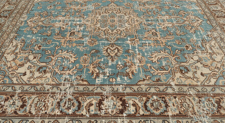 Close-up view of teal and beige patterned rug texture, showcasing intricate design, suggesting elegance and sophistication for home decor