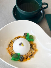 Delicious panna cotta dessert with sauce, fresh berries and mint on a gray background. Mousse-based desserts.