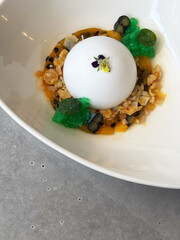 Delicious panna cotta dessert with sauce, fresh berries and mint on a gray background. Mousse-based desserts.