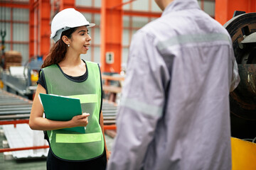 Engineer or technician training and teaching how to use machine control with coworker in factory