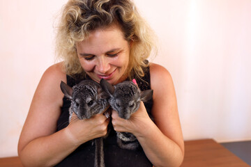 People care for and play with chinchillas.