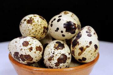 Quail eggs on black background, close-up shot