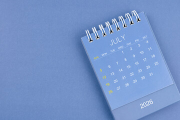 July 2026 calendar on blue color background. Desk calendar for planning and organizing.
