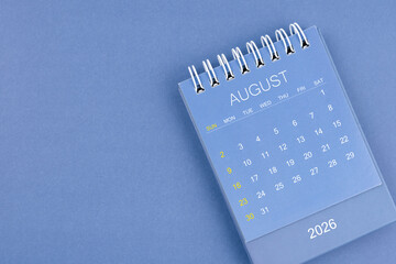 August 2026 calendar on blue color background. Desk calendar for planning and organizing.