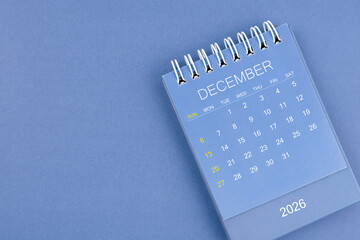 December 2026 calendar on blue color background. Desk calendar for planning and organizing.