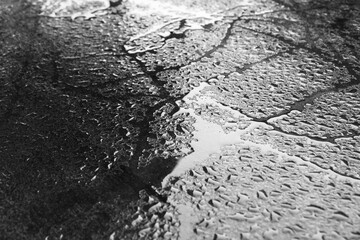 Wet texture bacground. Macro shot of water drops scattered over a wooden table, creationg a textured and fresh background for nature or abstract themes. Dramatic and contrast look, moody lighting, min