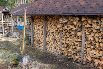 A firebox with stacked firewood in the utility yard