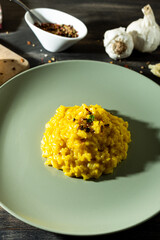 Saffron risotto in a rustic composition with garlic and parmesan cheese.