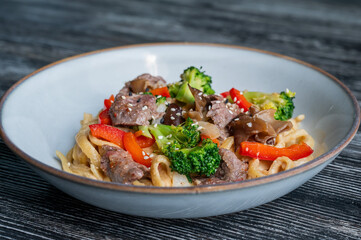 Top view of pasta with beef and broccoli. 
