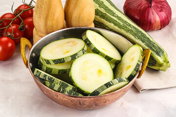 Raw green zucchini slices for cooking