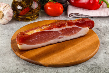 Piece prosciutto crudo over board