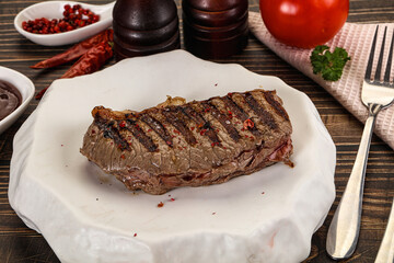 Grilled beef striploin steak with sauce