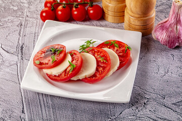 Italian caprese salad with mozzarella, tomato and basil