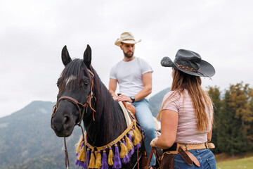 Authentic western riding school experience, cowboy learning horseback skills from a female...