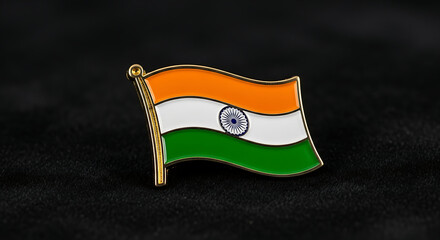 A close-up shot of an Indian flag pin with orange, white, and green stripes against a dark, textured background.
