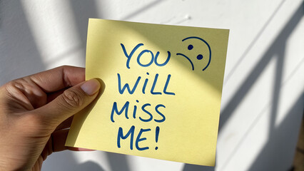 &ldquo;YOU WILL MISS ME!&rdquo; Handwritten Sticky Note with Sad Face &ndash; Dramatic Farewell Message on Light Surface
