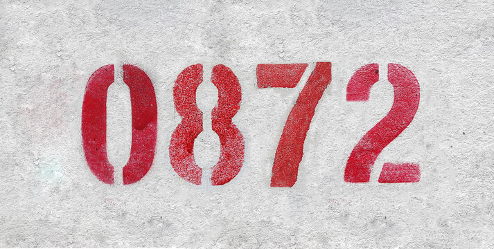 red spray-painted number 0872 sprayed onto a white wall.
