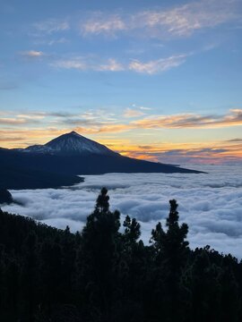 Mount Teide Overlooking a Sea of Clouds at Sunset &ndash; Dramatic Landscape on Tenerife with Glowing Sky, Striking Contrasts, and Volcanic Silhouette Above the Clouds in the Canary Islands