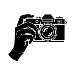 silhouette of a hand holding a vintage camera