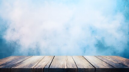 Wooden table surface in front of a light blue background with a smoky effect.