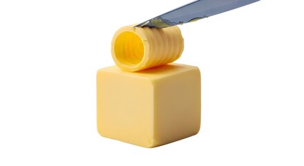 Creating a Butter Curl from a Block of Grass-Fed Butter, a Healthy Fat for a Ketogenic Diet, Isolated on White Background.