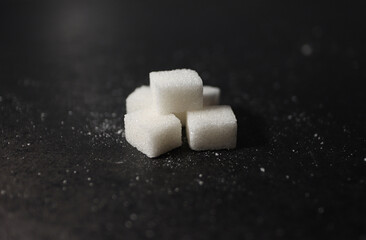 Stacked Sugar Cubes on Black Background – Minimalist Close-Up Composition with Contrast and...