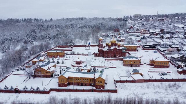Aerial View of Winter Village and Monastery: An aerial perspective reveals a picturesque winter scene of a village and monastery blanketed in snow, creating a serene and timeless atmosphere.