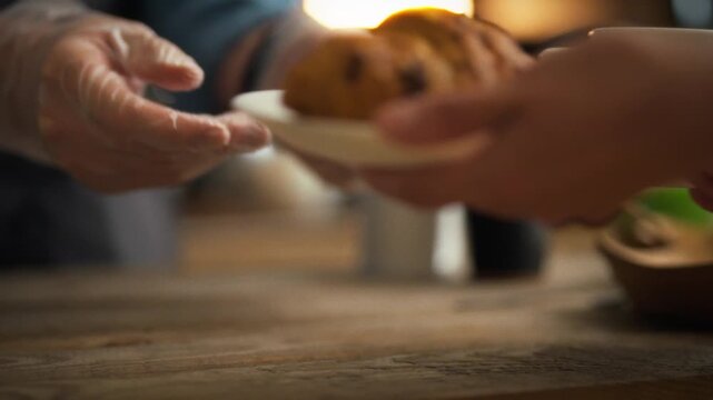 Atmospheric coffee shop. Cafe worker gives order to client close-up hands pass plate with freshly baked croissant. Fresh pastries on plate customer takes away