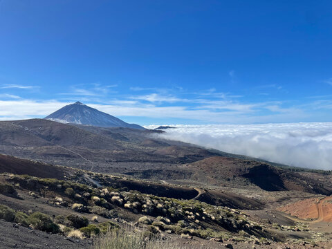 Daytime View of Mount Teide and Sea of Clouds &ndash; Volcanic Landscape with Native Vegetation of Tenerife, Bright Sky and Majestic Scenery in the Canary Islands&rsquo; Natural Park