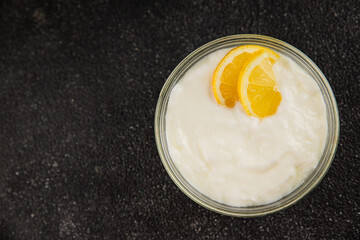 Lemon yogurt natural product skyr sour milk skir fresh delicious gourmet food background on the table rustic food top view copy space keto and paleo diet vegetarian food