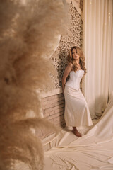 A blonde woman wearing white corset.
