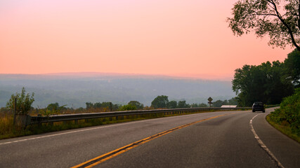 Wildfire smoke drifts over Okemo State Forest, casting a hazy veil along Vermont’s Highway 103 at...