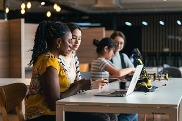 STEM Education Class With Teacher Guiding Diverse Students to Code and Build Robotic Arm Using Computers in Hands-On Engineering Activity
