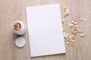Blank medical journal or notebook with white cover and medicines on table. Mockup for design © splitov27