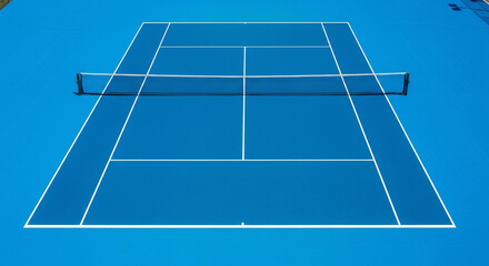 Vibrant Blue Hard Court Tennis Surface with Crisp White Lines and Net