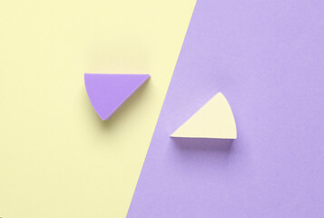 Triangular make-up sponges on pastel background. Top view