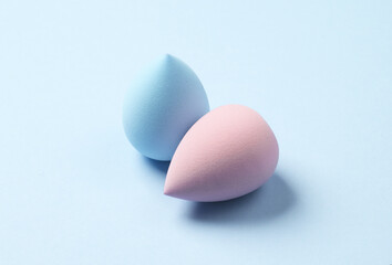 Make-up sponges, cosmetic beauty blenders on blue background