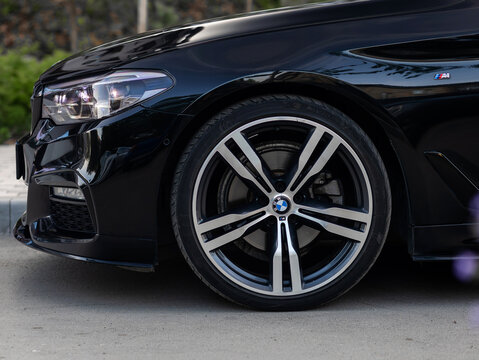 Novosibirsk, Russia -  July 10, 2024: black  BMW 5-series,  close-up of the bumper, alloy wheel, car detailing, wheel