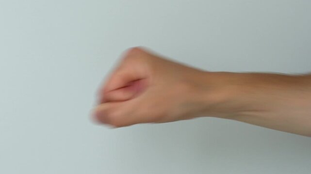 СТОКPunch on white background.
Man threatens with fist in anger.
Gesture of aggression and anger close-up.
Anger, aggression, punch, fight