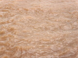 Turbulent Brown River Water Surface with Ripples