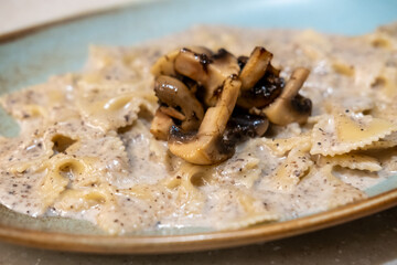 Farfalle truffle pasta served on plate. It is a pasta shaped like butterfly or bow tie