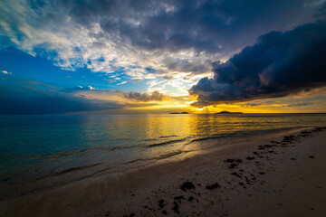 Dramatic sky over a tropical beach at sunset