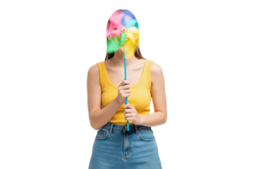 Playful young woman with her face obscured by a colorful spinning pinwheel.